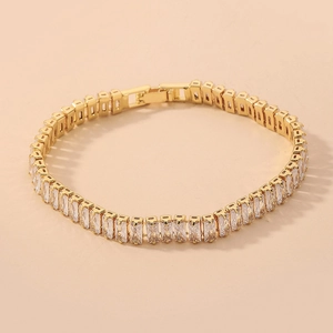 Detailed close-up of a luxury gold bracelet with rectangular pave-set cubic zirconia