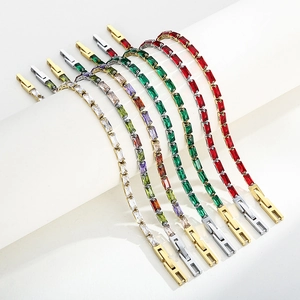 Detailed macro view of multi-colored zircon stones set in gold and silver square link bracelets