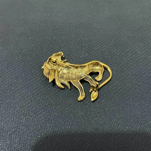 Detail view of the vintage gold lion brooch back showing pin clasp and brushed metal texture