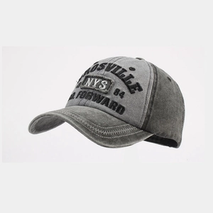 Close-up of vintage grey washed baseball cap with detailed embroidery and stitching