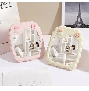Close-up of cute cartoon sheep desktop mirrors in pink and beige on a stylish desk