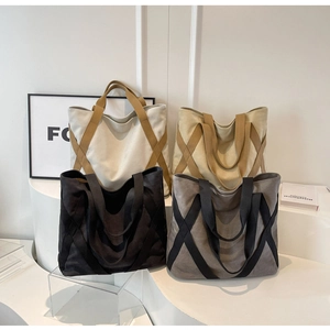 Collection of large canvas tote bags in white, khaki, black and grey on geometric stands