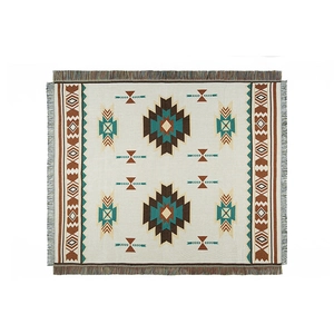 Bohemian woven sofa blanket with geometric patterns and fringe edges on white background