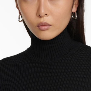 Minimalist irregular triangle hoop earrings in silver finish worn by a model