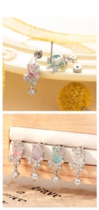 Macro shot of butterfly zircon earrings with screw backs in pink, blue, purple, and white