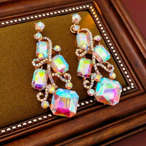 Detail of vintage square crystal earrings with golden alloy frame and colorful rhinestones