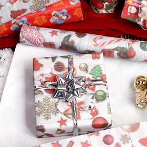 Christmas gift wrapping paper with silver ribbon on a box, marble background