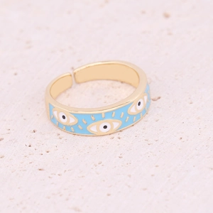 Detailed view of light blue enamel evil eye patterns on a gold adjustable metal ring