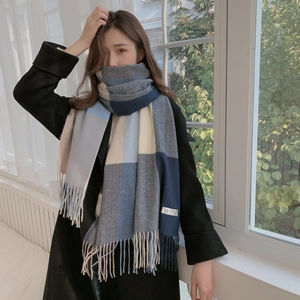 Detail of soft plaid cashmere scarf with fringes and authentic 100% cashmere label