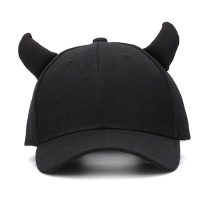 Detail shot of the 3D devil horn decoration on a black cotton twill baseball cap