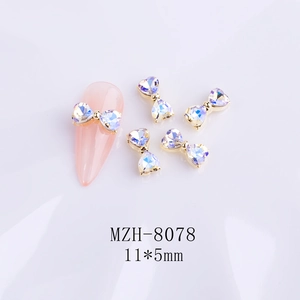Detail view of aurora crystal bow nail charms with 11x5mm size measurements