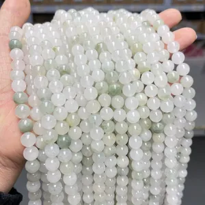 Macro detail of translucent light green and milky white jadeite beads for jewelry DIY
