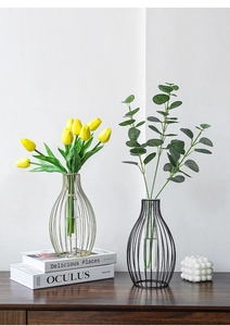 Detail view of modern geometric wire frame vases with glass tubes for tulips
