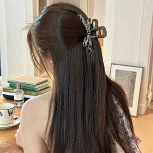 Grey marble tortoiseshell acrylic bow hair claw clip for thick hair shown on model