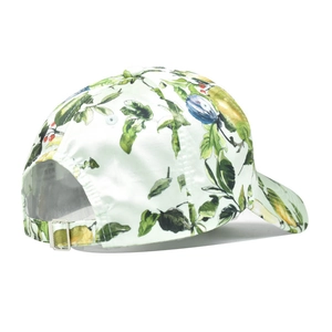 Detail of adjustable metal buckle and botanical fruit print on a baseball cap