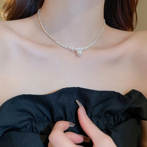 Detailed view of zircon pearl necklace on model showing elegant fit and white luster