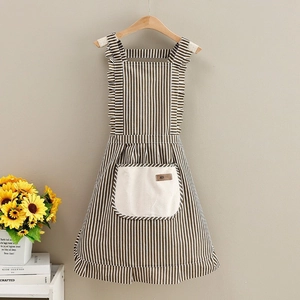 Detail of striped apron showing ruffled shoulder straps and large plush pocket with DK tag