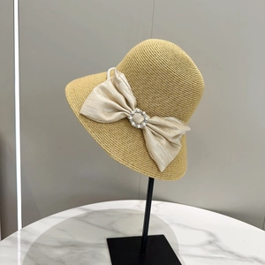 Elegant straw sun hat with champagne silk bow and pearl buckle for beach vacation