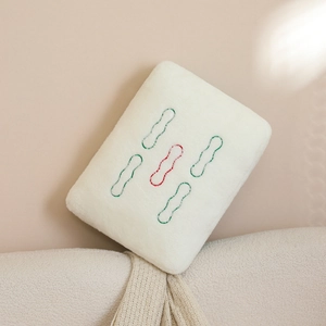 Detail of creative Mahjong plush pillow with soft white faux fur and green embroidery