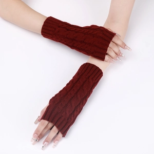 Detail of cable knit fingerless gloves in deep red, showing texture and arm sleeve design