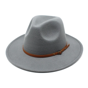 Detail of grey felt fedora hat featuring a brown leather strap and metal buckle
