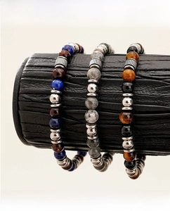 Detailed shot of 7mm tiger eye and map stone beaded bracelets with silver spacers