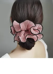 Detailed back view of a pink pleated chiffon scrunchie with elegant black edge trimming