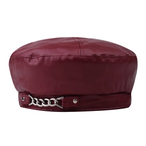 Chic burgundy PU leather beret with silver chain detail in a minimalist studio shot