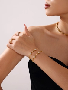 Luxurious 18K gold-plated jewelry set featuring sparkling zircon stones on a female model
