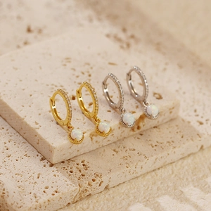 Close-up of S925 silver hoop earrings with white opal drops and zircon inlay