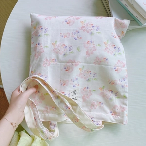 Close-up of floral cotton tote bag with Animals Nature label and shoulder straps