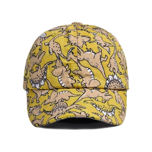 Detailed view of yellow kids baseball cap with cartoon dinosaur patterns and waterproof fabric