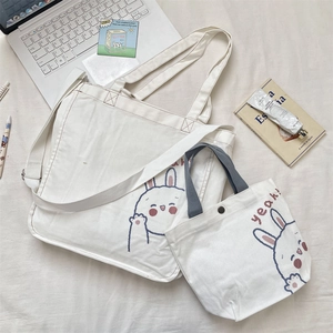 Juego de dos bolsas de lona blanca con lindos estampados de conejos y correa ajustable