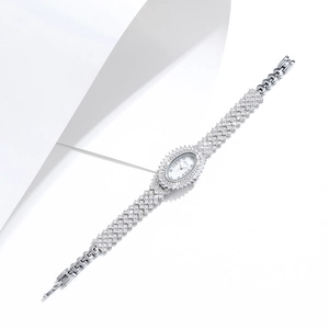 Close-up of elegant oval silver watch with luxury zircon diamond studded metal links