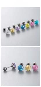 Macro detail of F136 titanium ear studs featuring colorful firework zircon and screw ball back