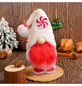 Detail of Christmas gnome with white plush hat and red beard in a cozy winter decor setting