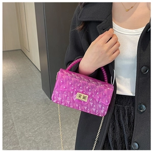 Magenta transparent jelly bag with diamond quilt pattern and gold chain strap detail