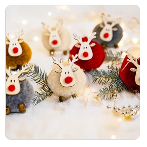 Detail of colorful plush reindeer ornaments with wooden heads and red noses for Christmas decor