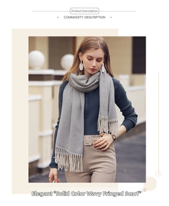 Detail view of grey herringbone pattern scarf with soft fringe tassels for women