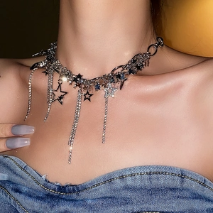 Close-up of silver star tassel necklace with sparkling rhinestones worn on a neck