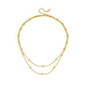 Elegant gold double-layered snake bone necklace with polished metal bead accents