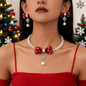 Christmas jewelry set with red bows, pearl necklaces, and rhinestone snowflake pendants