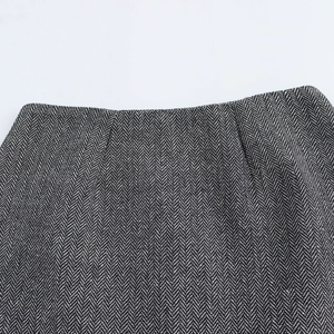 Elegant black and white herringbone wool jacket with cinched waist and matching skirt set