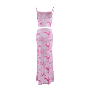 Detail shot of the pink printed fabric texture on a crop top and maxi skirt set