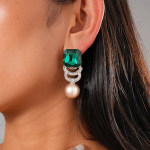 Elegant emerald square drop earrings with pearls and diamonds shown on a model