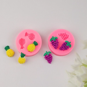 Mini silicone fruit molds with finished pineapple and grape shapes for DIY baking crafts