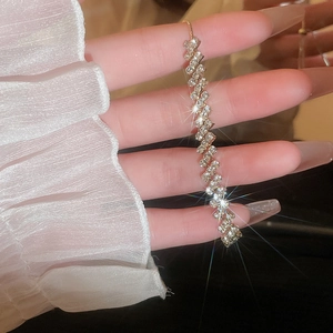 Detail shot of wavy silver-tone bracelet with sparkling zircons and adjustable slider clasp