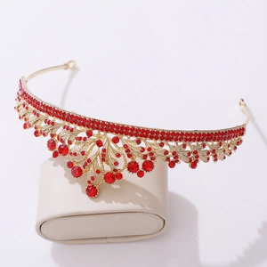 Detailed macro view of golden bridal crown with red rhinestones and teardrop pendants