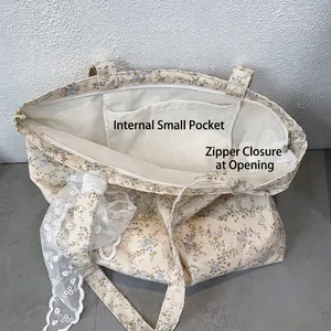 Floral canvas tote bag with blue small flower patterns and white lace ribbon detail