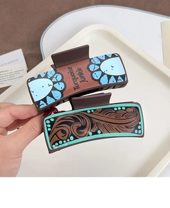 Detail of leather poker hair claw clips with turquoise junkie print and western pattern